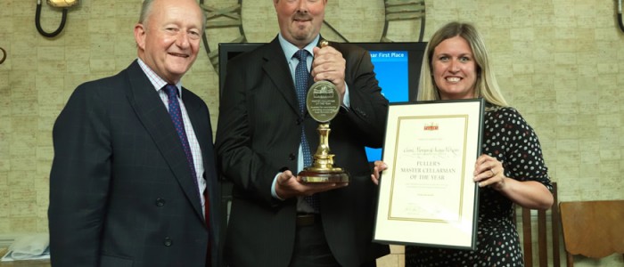 Michael Turner, Fuller’s Chairman, presents Angus McKean and Claire Morgan of the Red Lion, Barnes, with their Master Cellarman of the Year award and gong